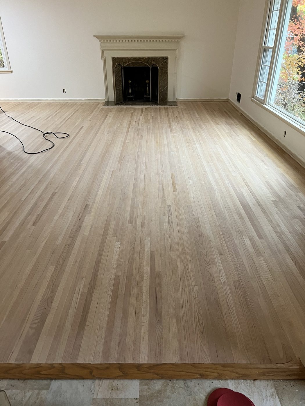 Bare white oak hardwood floor after sanding, ready for stain